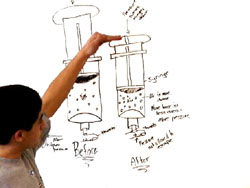 Student demonstrates model on whiteboard